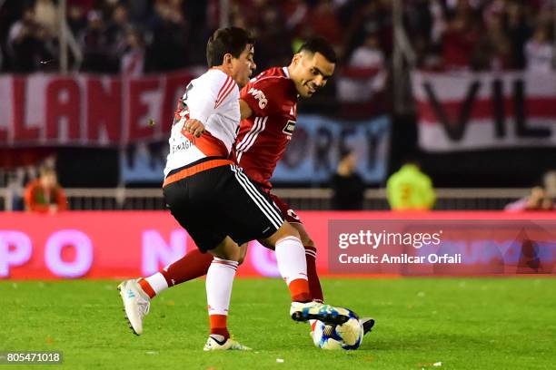 Marcelo Gallardo and Gabriel Mercado fight for the ball during Fernando Cavenaghi's farewell match at Monumental Stadium on July 01, 2017 in Buenos...