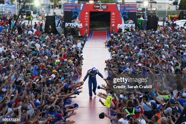 Dale Earnhardt Jr., driver of the Nationwide Chevrolet, shakes hands with fans on stage before the Monster Energy NASCAR Cup Series 59th Annual Coke...