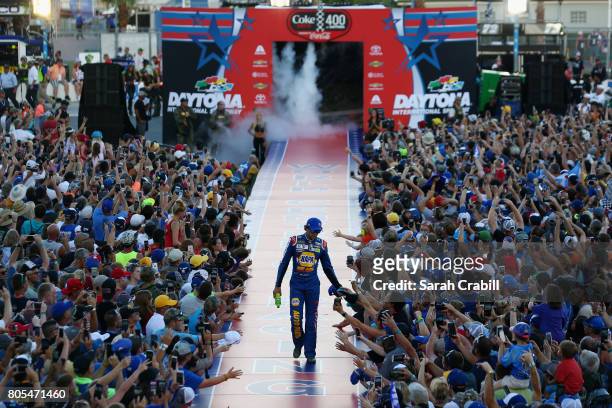 Chase Elliott, driver of the NAPA Patriotic Chevrolet, shakes hands with fans before the Monster Energy NASCAR Cup Series 59th Annual Coke Zero 400...