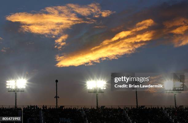 General view of the front stretch grandstands as the sun sets during the Monster Energy NASCAR Cup Series 59th Annual Coke Zero 400 Powered By...