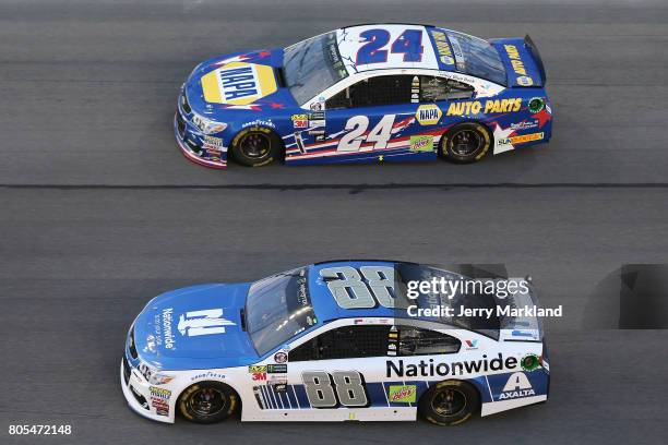 Chase Elliott, driver of the NAPA Patriotic Chevrolet, races Dale Earnhardt Jr., driver of the Nationwide Chevrolet, during the Monster Energy NASCAR...
