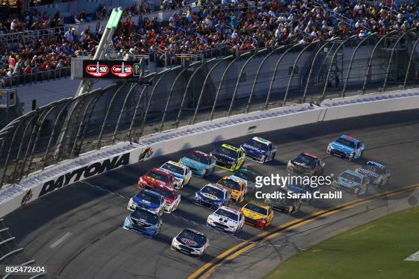 Brad Keselowski, driver of the Detroit Genuine Parts Ford, and Kevin Harvick, driver of the Jimmy John's Ford, lead a pack of cars during the Monster...