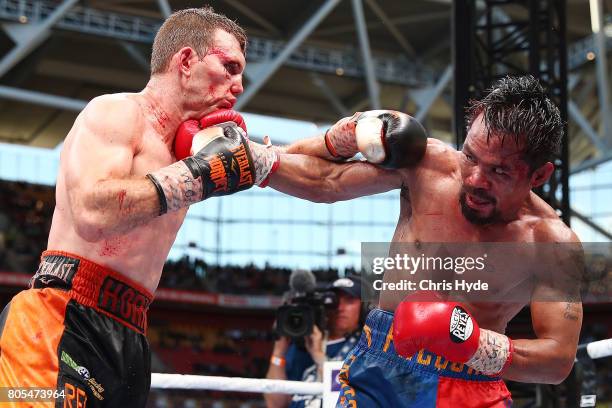 Jeff Horn of Australia and Manny Pacquiao exchange punches during the WBO World Welterweight Title Fight at Suncorp Stadium on July 2, 2017 in...