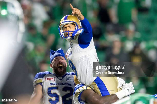 Justin Medlock and Thomas Miles of the Winnipeg Blue Bombers celebrate after Medlock kicked the game winning field goal in overtime in the game...