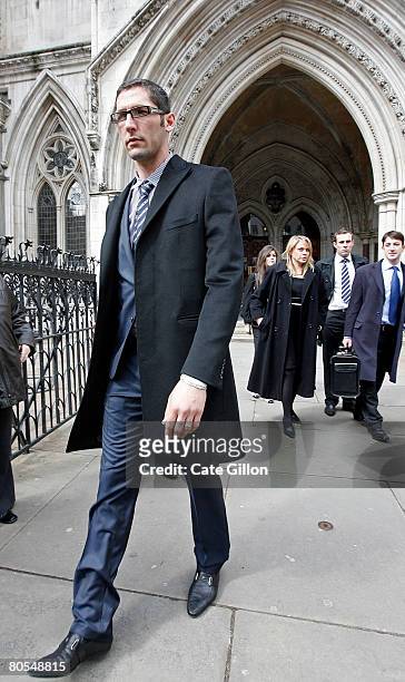 Italian football player Marco Materazzi walks outside the High Court on April 7, 2008 in London, England. Materazzi accepted an apology regarding...