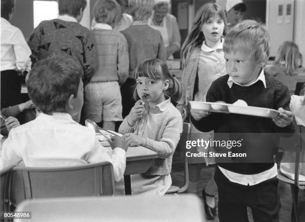 Primary school pupils in the dining hall at Hardwicke Parochial School in Herefordshire, June 1987.