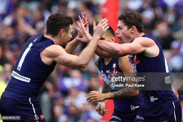 Hayden Ballantyne and Lachie Neale of the Dockers celebrate a goal during the round 15 AFL match between the Fremantle Dockers and the St Kilda...