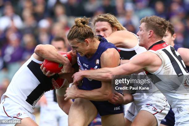 Nathan Fyfe of the Dockers contests for the ball against Luke Dunstan, Sam Gilbert and Jack Newnes of the Saints during the round 15 AFL match...