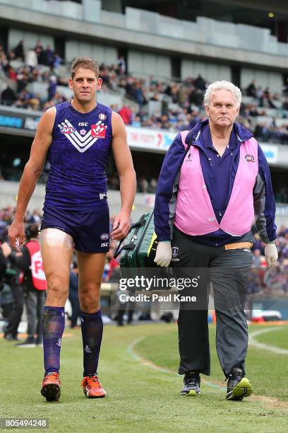 Aaron Sandilands of the Dockers walks to the change rooms with the ice on his right hamstring during the round 15 AFL match between the Fremantle...