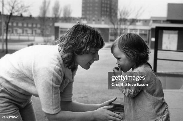 Young single mother and her child living on a housing estate in Middlesbrough, circa 1984.