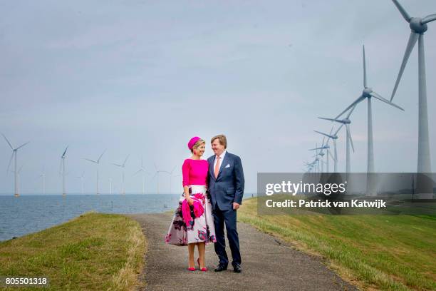 King Willem-Alexander of The Netherlands and Queen Maxima of The Netherlands pose in front of the wind mills on June 29, 2017 in Noordoostpolder,...