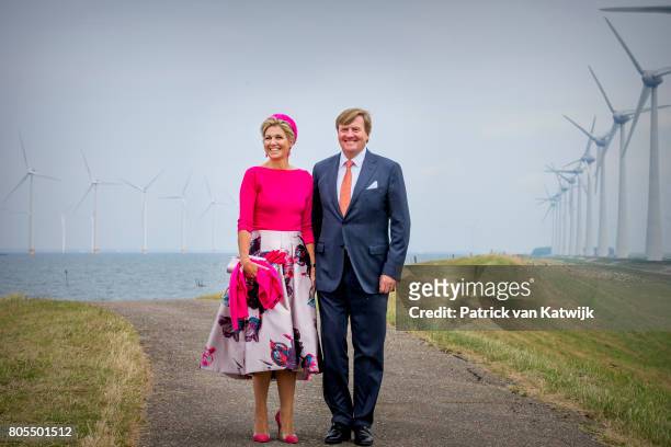 King Willem-Alexander of The Netherlands and Queen Maxima of The Netherlands pose in front of the wind mills on June 29, 2017 in Noordoostpolder,...