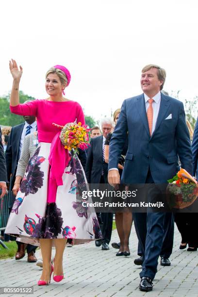 King Willem-Alexander of The Netherlands and Queen Maxima of The Netherlands walk through the neighborhood on June 29, 2017 in Nagele, Netherlands.