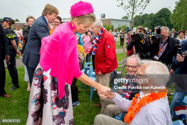 King Willem-Alexander of The Netherlands and Queen Maxima of The Netherlands walk through the neighborhood on June 29, 2017 in Nagele, Netherlands.