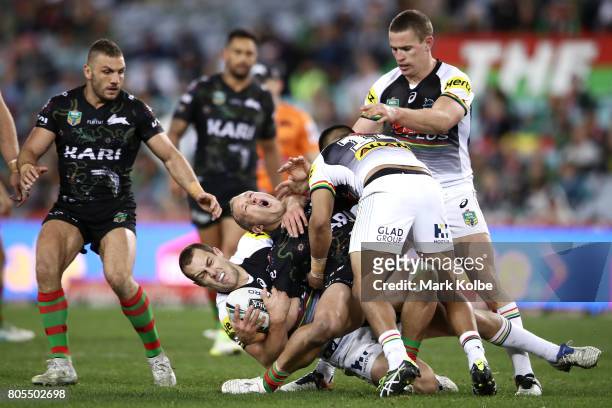 Jason Clark of the Rabbitohs is tackled during the round 17 NRL match between the South Sydney Rabbitohs and the Penrith Panthers at ANZ Stadium on...