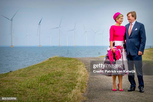 King Willem-Alexander of The Netherlands and Queen Maxima of The Netherlands pose in front of the wind mills on June 29, 2017 in Noordoostpolder,...