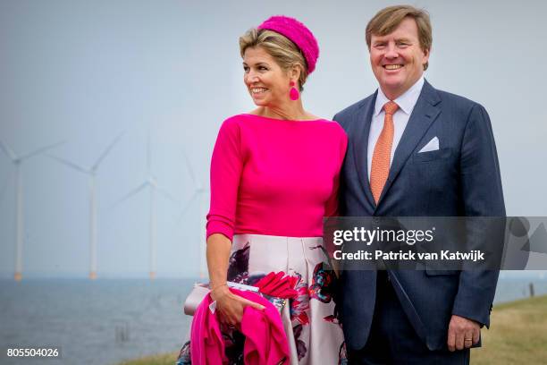 King Willem-Alexander of The Netherlands and Queen Maxima of The Netherlands pose in front of the wind mills on June 29, 2017 in Noordoostpolder,...