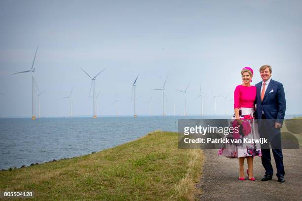 King Willem-Alexander of The Netherlands and Queen Maxima of The Netherlands pose in front of the wind mills on June 29, 2017 in Noordoostpolder,...