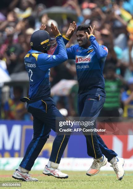 Sri Lanka's Wanidu Hasaranga celebrates with his teammates after he dismissed Zimbabwe's Tendai Chatara during the second one-day international...