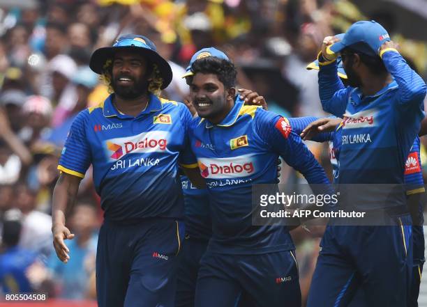 Sri Lanka's Wanidu Hasaranga celebrates with his teammates after he dismissed Zimbabwe's Tendai Chatara during the second one-day international...