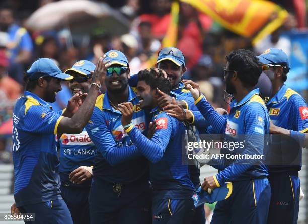 Sri Lanka's Wanidu Hasaranga celebrates with his teammates after he dismissed Zimbabwe's Tendai Chatara during the second one-day international...