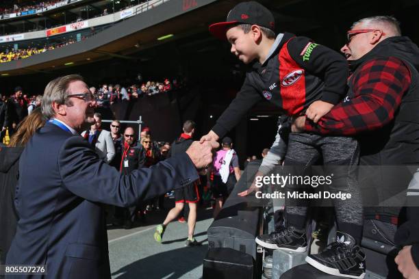 Bombers legend Kevin Sheedy is greeted by a fan during the round 15 AFL match between the Essendon Bombers and the Brisbane Lions at Etihad Stadium...