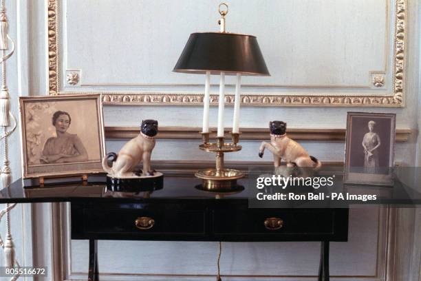 Table with portraits of the Duchess of Windsor, left, and Queen Mary in the home of the Duke and Duchess of Windsor in the Bois de Boulogne, Paris.