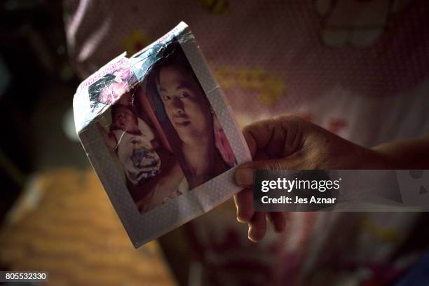 Teresa Galoy holding a photo of her son, Bernard Salvador inside their house on July 1, 2017 in Quezon city, Philippines. Bernard Salvador was killed...