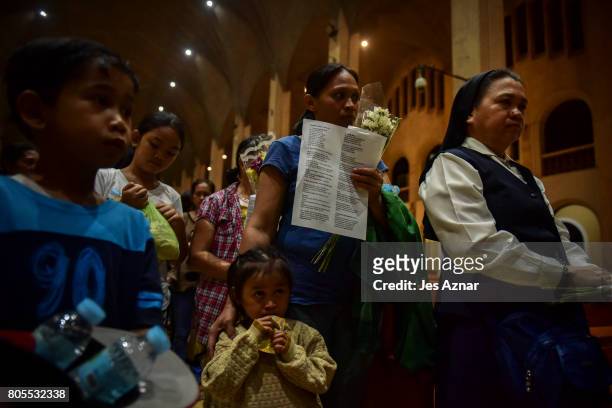 Relatives of the victims of drug related killings say their prayers inside a Catholic churhc on February 18, 2017 in Manila, Philippines. The...