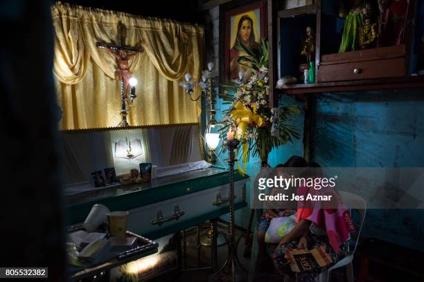 Lilly Padilla sits near his husband's coffin during his wake on June 30, 2017 in Quezon city, Philippines. Lilly's common-law husband, Sonny...