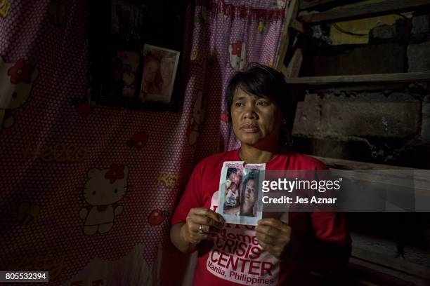 Teresa Galoy holding a photo of her son, Bernard Salvador inside their house on July 1, 2017 in Quezon city, Philippines. Bernard Salvador was killed...