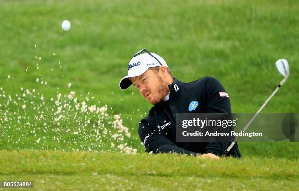 George Coetzee of South Africa plays out of a bunker on the practice ground during day four of the HNA Open de France at Le Golf National on July 2,...