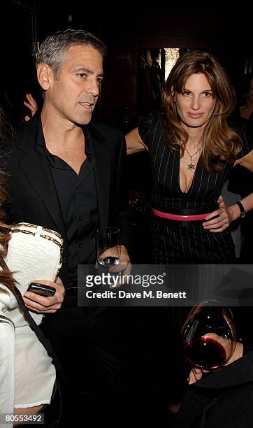 George Clooney and Jemima Khan attend the Harpers Bazaar dinner for George Clooney hosted by editor Lucy Yeomans, at L'Atelier de Joel Robuchon on...