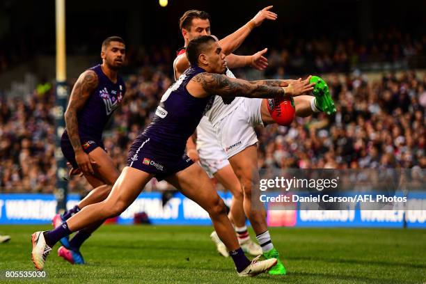 Michael Walters of the Dockers smothers the kick of Maverick Weller of the Saints during the 2017 AFL round 15 match between the Fremantle Dockers...