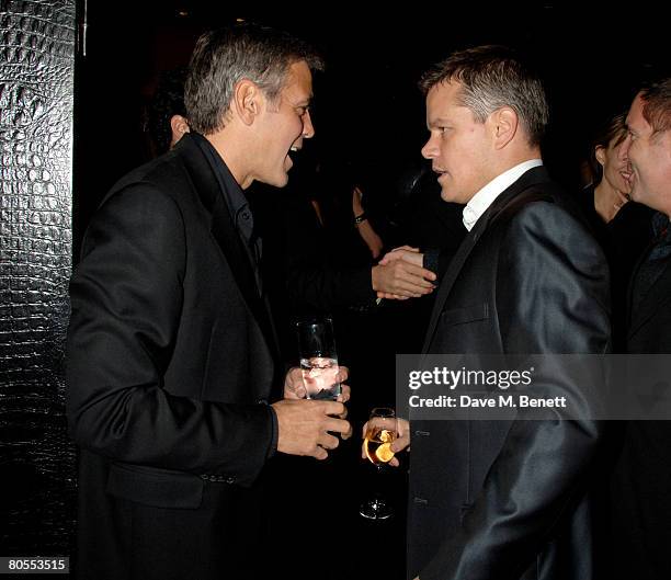 George Clooney and Matt Damon attend the Harpers Bazaar dinner for George Clooney hosted by editor Lucy Yeomans, at L'Atelier de Joel Robuchon on...