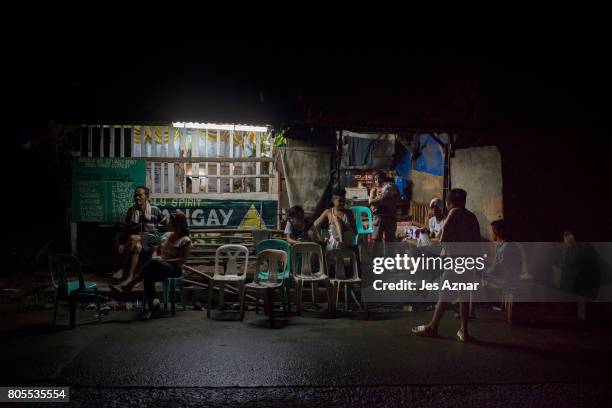 Family and friends attend the wake of Manuel Borbe inside a village outpost on June 28, 2017 in Manila, Philippines. Manuel was allegedly involved in...