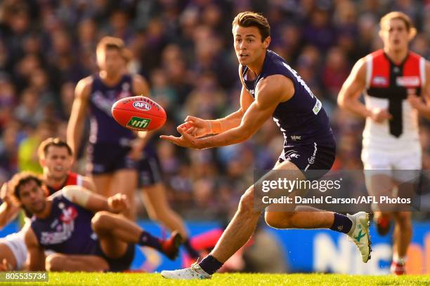 Lachie Weller of the Dockers handpasses the ball during the 2017 AFL round 15 match between the Fremantle Dockers and the St Kilda Saints at Domain...