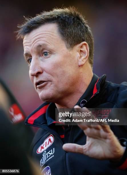 John Worsfold, Senior Coach of the Bombers addresses his players during the 2017 AFL round 15 match between the Essendon Bombers and the Brisbane...