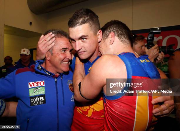 Chris Fagan, Senior Coach of the Lions celebrates with Tom Rockliff and Dayne Zorko of the Lions during the 2017 AFL round 15 match between the...