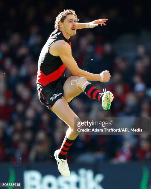 Joe Daniher of the Bombers kicks the ball during the 2017 AFL round 15 match between the Essendon Bombers and the Brisbane Lions at Etihad Stadium on...