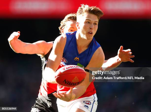 Alex Witherden of the Lions is tackled by Darcy Parish of the Bombers during the 2017 AFL round 15 match between the Essendon Bombers and the...