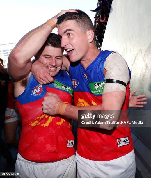 Dayne Zorko and Tom Rockliff of the Lions celebrate during the 2017 AFL round 15 match between the Essendon Bombers and the Brisbane Lions at Etihad...