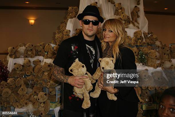 Nicole Richie and Joel Madden greet children at the Richie Madden Children's Foundation Holiday Party on December 22,2007 in Los Angeles,California....