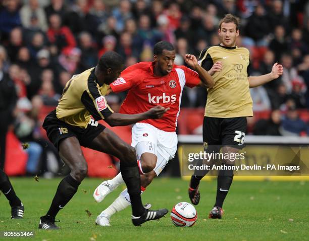 Charlton Athletic's Lloyd Sam makes his way past Milton Keynes Dons' Peter leven and Darren Powell