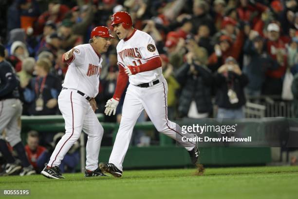 Ryan Zimmerman of the Washington Nationals gets congratulated third base coach Tim Tolman#18 after hitting the game winning home-run in the bottom of...