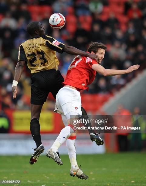 Charlton Athletic's David mooney and Milton Keynes Dons' Darren Powell battle for the ball