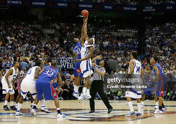 Robert Dozier of the Memphis Tigers and Darrell Arthur of the Kansas Jayhawks both jump for the tip-off to start the first half during the 2008 NCAA...