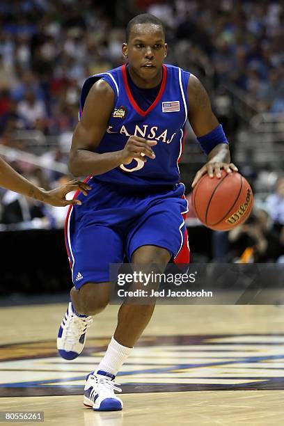 Russell Robinson of the Kansas Jayhawks moves the ball while taking on the North Carolina Tar Heels during the National Semifinal game of the NCAA...