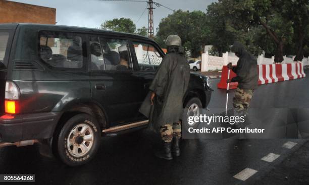 Malian soldiers check a car, outside the presidential palace in Bamako, on July 2 during a G5 Sahel summit, to boost Western backing for a regional...