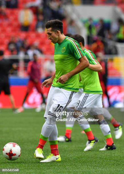 Mexico's midfielder Hector Herrera warms up with teammates ahead of the 2017 FIFA Confederations Cup third place football match between Portugal and...